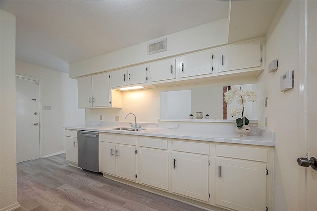 3968 Belle Park Dr, Houston, TX 77072 - kitchen with dishwasher, a sink, light wood-style floors, light countertops, and white cabinets