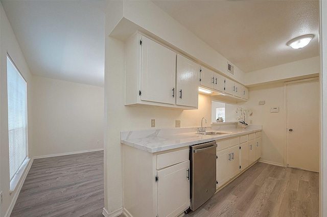 3968 Belle Park Dr, Houston, TX 77072 - kitchen with dishwasher, a sink, light wood finished floors, light countertops, and white cabinets