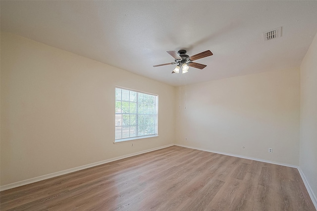 3968 Belle Park Dr, Houston, TX 77072 - spare room featuring light wood-type flooring, ceiling fan, and baseboards