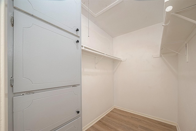 3968 Belle Park Dr, Houston, TX 77072 - walk in closet with light wood-style floors and stacked washing machine and dryer