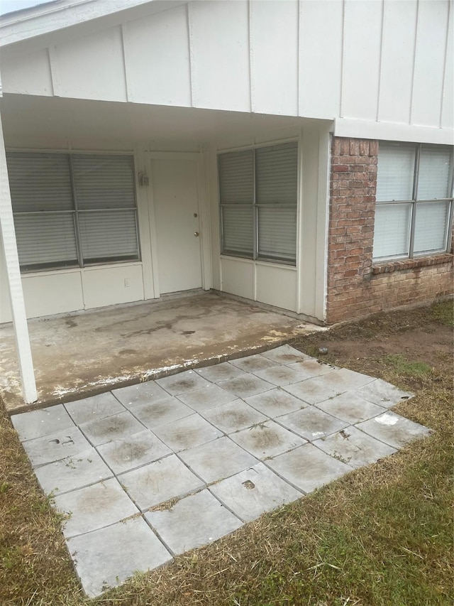 22307 Fincastle Dr, Katy, TX 77450 - entrance to property with a patio, brick siding, and board and batten siding