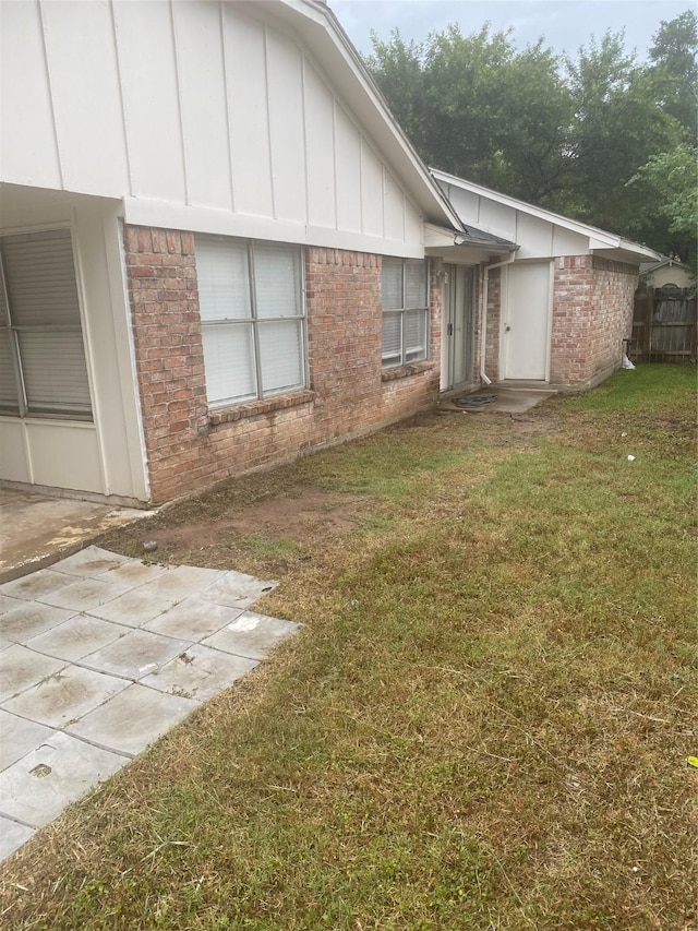 22307 Fincastle Dr, Katy, TX 77450 - view of side of property with brick siding, a patio, and board and batten siding