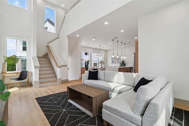 2949 Delafield St, Houston, TX 77023 - living area with stairs, wood finished floors, and recessed lighting