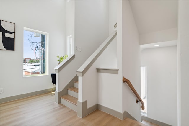 2949 Delafield St, Houston, TX 77023 - stairway with wood finished floors, a high ceiling, and baseboards
