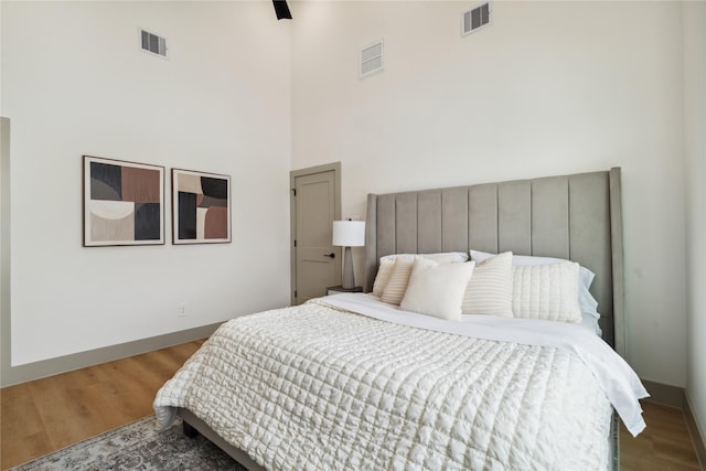 2949 Delafield St, Houston, TX 77023 - bedroom featuring a high ceiling, wood finished floors, and baseboards