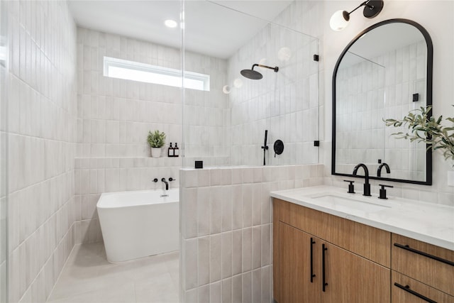 2949 Delafield St, Houston, TX 77023 - full bathroom featuring tile walls, a soaking tub, vanity, and tiled shower