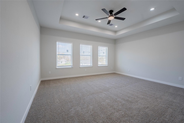 318 New Hampshire St, Houston, TX 77029 - spare room with a tray ceiling, baseboards, a ceiling fan, carpet, and recessed lighting
