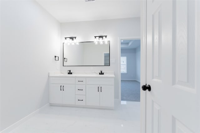 318 New Hampshire St, Houston, TX 77029 - bathroom featuring baseboards, double vanity, and marble finish floors