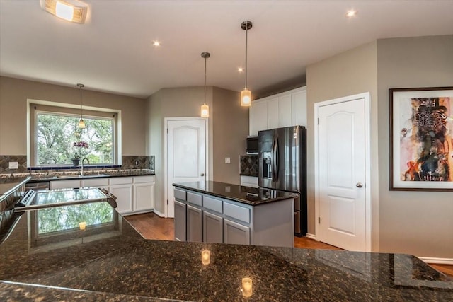 1328 Lakepark Dr, Lakehills, TX 78063 - kitchen featuring stainless steel fridge, a sink, backsplash, dark wood-type flooring, and white cabinets