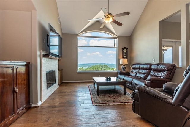 1328 Lakepark Dr, Lakehills, TX 78063 - living area featuring ceiling fan, vaulted ceiling, dark wood finished floors, and a glass covered fireplace