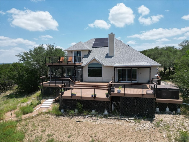 1328 Lakepark Dr, Lakehills, TX 78063 - back of property with a shingled roof, solar panels, a chimney, a balcony, and a deck