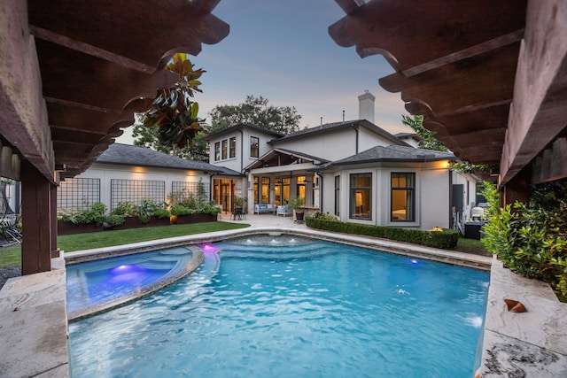 5659 Willers Way, Houston, TX 77056 - pool at dusk featuring a patio and a pool with connected hot tub