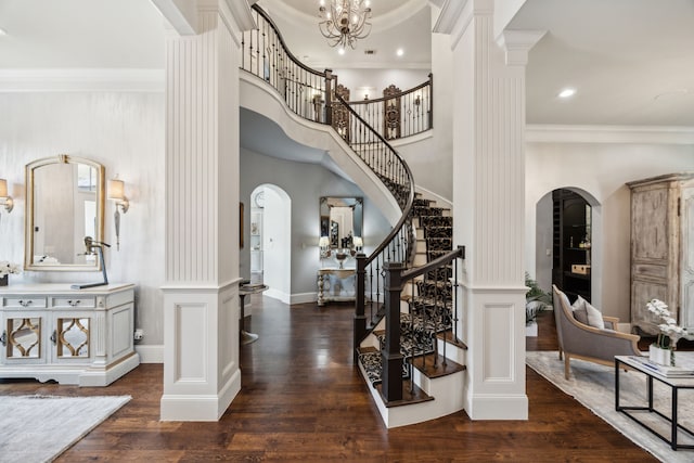 5659 Willers Way, Houston, TX 77056 - entrance foyer with arched walkways, ornamental molding, stairs, wood finished floors, and ornate columns