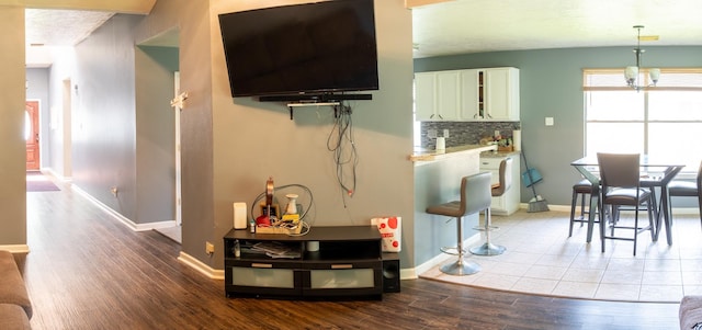 3906 Cyril Dr, Humble, TX 77396 - living room with wood finished floors, baseboards, and a chandelier