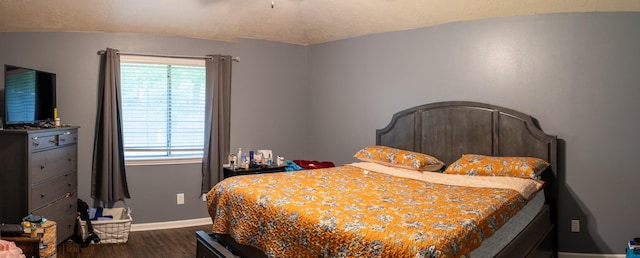 3906 Cyril Dr, Humble, TX 77396 - bedroom featuring dark wood finished floors, multiple windows, baseboards, and ceiling fan
