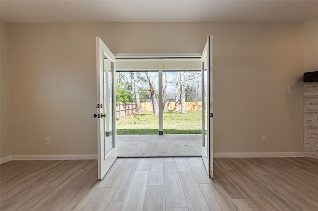 217 E Southland Ave, Alvin, TX 77511 - foyer entrance with light wood-style floors and baseboards