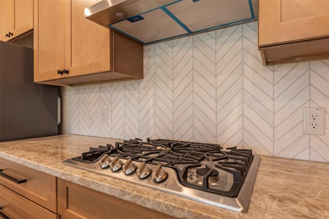 217 E Southland Ave, Alvin, TX 77511 - kitchen with stainless steel gas stovetop, light countertops, and exhaust hood