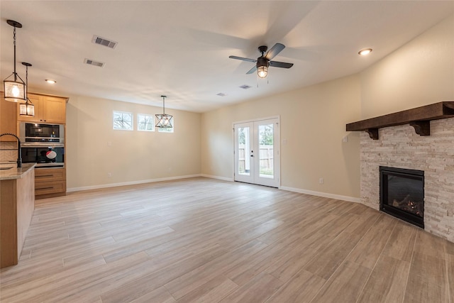 217 E Southland Ave, Alvin, TX 77511 - unfurnished living room with a ceiling fan, light wood-style floors, a fireplace, baseboards, and recessed lighting