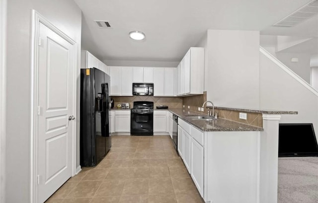 17439 Hayley Springs Ct, Humble, TX 77396 - kitchen with black appliances, a sink, dark stone counters, and white cabinets