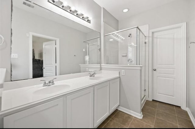 17439 Hayley Springs Ct, Humble, TX 77396 - bathroom featuring tile patterned flooring, double vanity, a shower stall, and baseboards