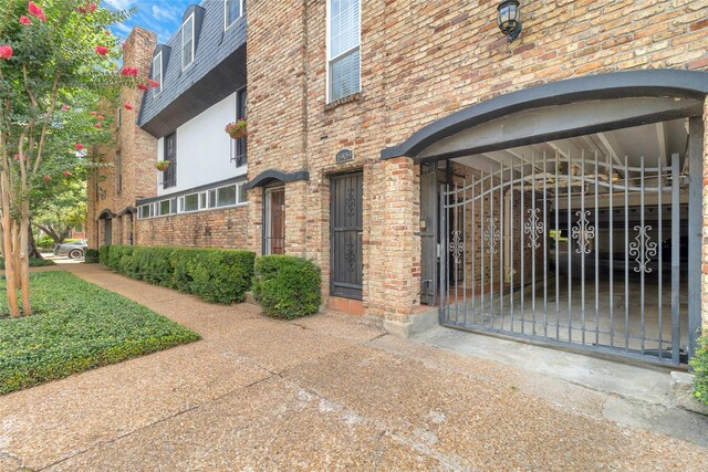 1909 Brun St Unit 17, Houston, TX 77019 - doorway to property featuring brick siding and a gate