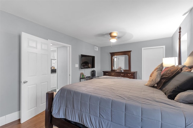 1909 Brun St Unit 17, Houston, TX 77019 - bedroom featuring wood finished floors, a ceiling fan, and baseboards