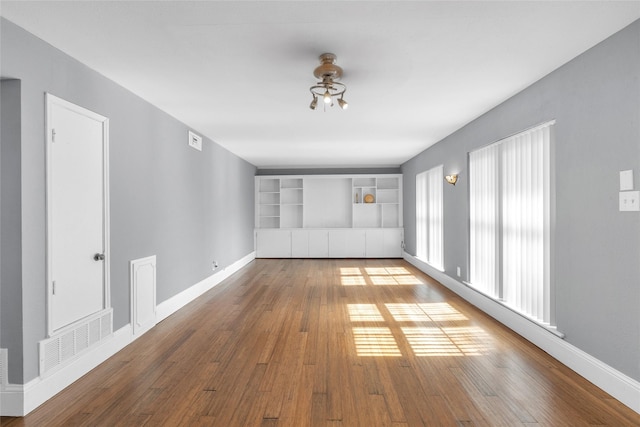 1909 Brun St Unit 17, Houston, TX 77019 - unfurnished room featuring hardwood / wood-style flooring, baseboards, and a ceiling fan