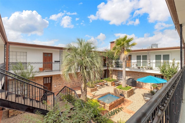 1909 Brun St Unit 17, Houston, TX 77019 - balcony featuring view of pool area, an outdoor hot tub, and stairway