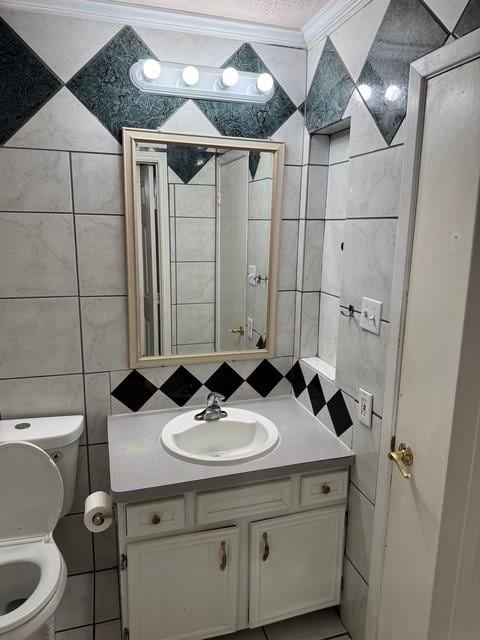 13023 High Star Dr, Houston, TX 77072 - bathroom featuring tile walls, crown molding, vanity, and toilet
