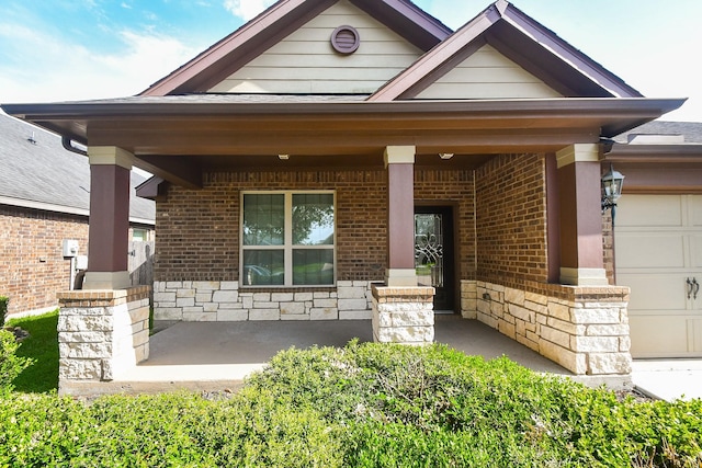 19527 Sundance Edge Ct, Richmond, TX 77407 - view of front facade featuring covered porch, brick siding, stone siding, and a garage