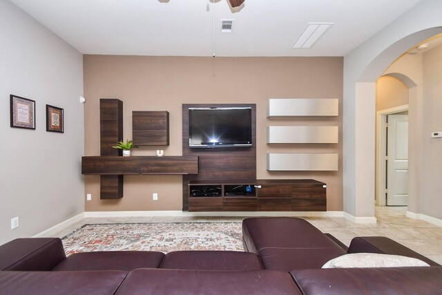 19527 Sundance Edge Ct, Richmond, TX 77407 - tiled living room featuring a ceiling fan, arched walkways, and baseboards