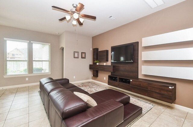 19527 Sundance Edge Ct, Richmond, TX 77407 - living room with ceiling fan, arched walkways, light tile patterned floors, and baseboards