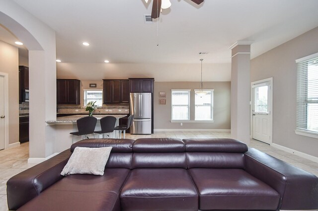 19527 Sundance Edge Ct, Richmond, TX 77407 - living area featuring ceiling fan, light tile patterned flooring, baseboards, recessed lighting, and arched walkways