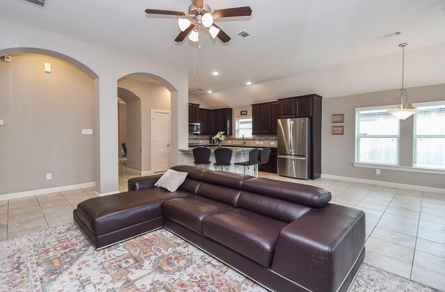 19527 Sundance Edge Ct, Richmond, TX 77407 - living area featuring ceiling fan, light tile patterned floors, arched walkways, baseboards, and recessed lighting