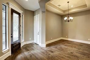 2814 Rosewood St, Houston, TX 77004 - entrance foyer featuring dark wood-type flooring, baseboards, a chandelier, and healthy amount of natural light