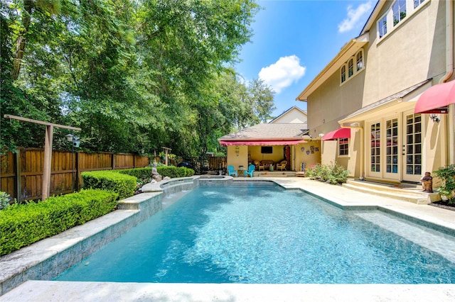 62 W Mirror Ridge Cir, The Woodlands, TX 77382 - view of swimming pool with french doors, a patio, and a fenced backyard