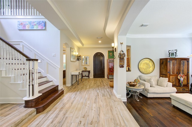 62 W Mirror Ridge Cir, The Woodlands, TX 77382 - foyer featuring arched walkways, hardwood / wood-style flooring, crown molding, and stairs