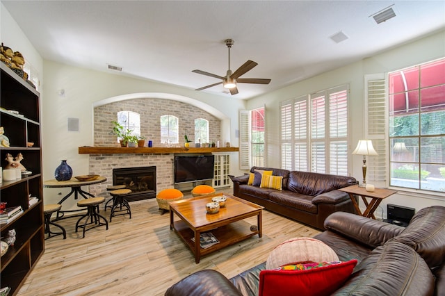 62 W Mirror Ridge Cir, The Woodlands, TX 77382 - living room featuring a ceiling fan, wood finished floors, and a brick fireplace