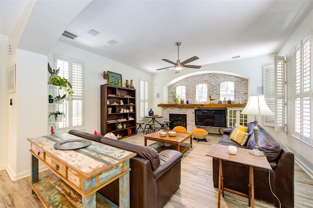 62 W Mirror Ridge Cir, The Woodlands, TX 77382 - living area featuring a ceiling fan, light wood-style flooring, a fireplace, and baseboards