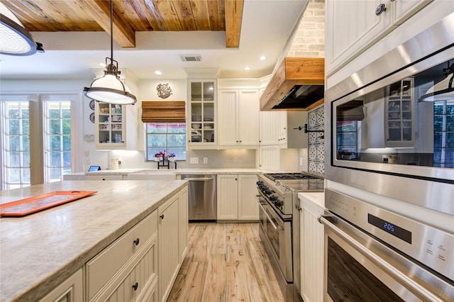 62 W Mirror Ridge Cir, The Woodlands, TX 77382 - kitchen featuring stainless steel appliances, light wood-style floors, wood ceiling with exposed beams, custom exhaust hood, and a sink