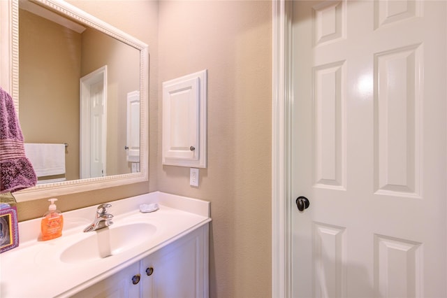 62 W Mirror Ridge Cir, The Woodlands, TX 77382 - bathroom featuring vanity and a textured wall