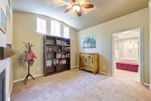 62 W Mirror Ridge Cir, The Woodlands, TX 77382 - living area with vaulted ceiling, carpet, a ceiling fan, a tiled fireplace, and baseboards