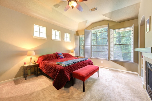 62 W Mirror Ridge Cir, The Woodlands, TX 77382 - bedroom with carpet floors, baseboards, a fireplace, lofted ceiling, and ceiling fan