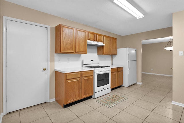 11539 Byronstone Dr, Houston, TX 77066 - kitchen featuring white appliances, under cabinet range hood, light countertops, baseboards, and light tile patterned floors