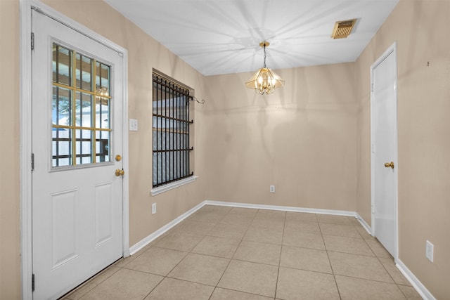 11539 Byronstone Dr, Houston, TX 77066 - unfurnished dining area with a chandelier, light tile patterned floors, and baseboards