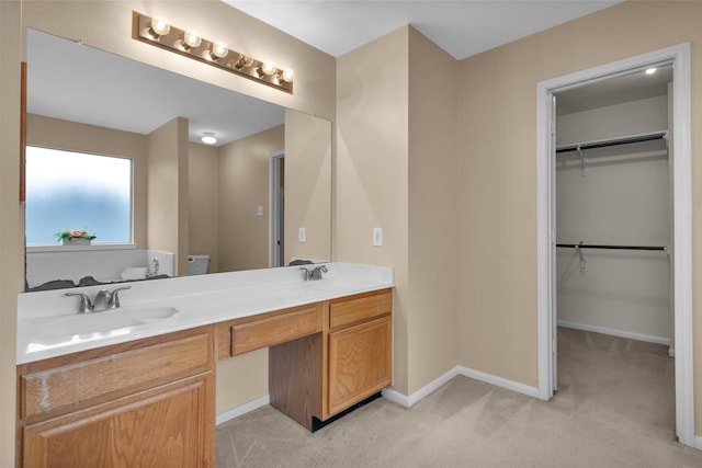 11539 Byronstone Dr, Houston, TX 77066 - full bathroom featuring double vanity, baseboards, a walk in closet, and toilet