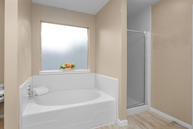 11539 Byronstone Dr, Houston, TX 77066 - bathroom featuring a bath, a stall shower, and baseboards