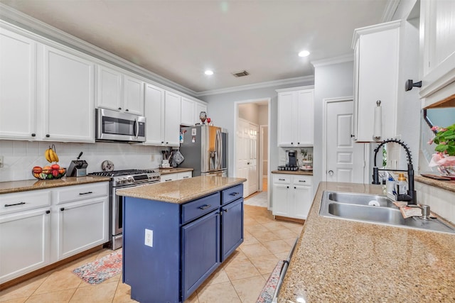 10010 Silverwood Way, Houston, TX 77070 - kitchen featuring appliances with stainless steel finishes, blue cabinetry, a sink, white cabinets, and light tile patterned floors