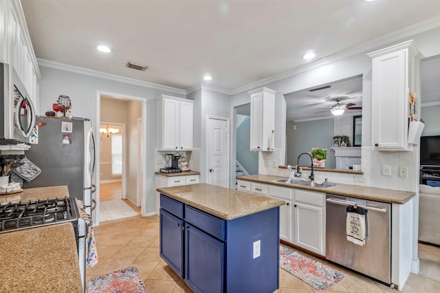 10010 Silverwood Way, Houston, TX 77070 - kitchen with appliances with stainless steel finishes, blue cabinetry, a sink, white cabinetry, and backsplash