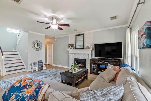 10010 Silverwood Way, Houston, TX 77070 - tiled living room featuring ceiling fan, stairway, a stone fireplace, ornamental molding, and baseboards